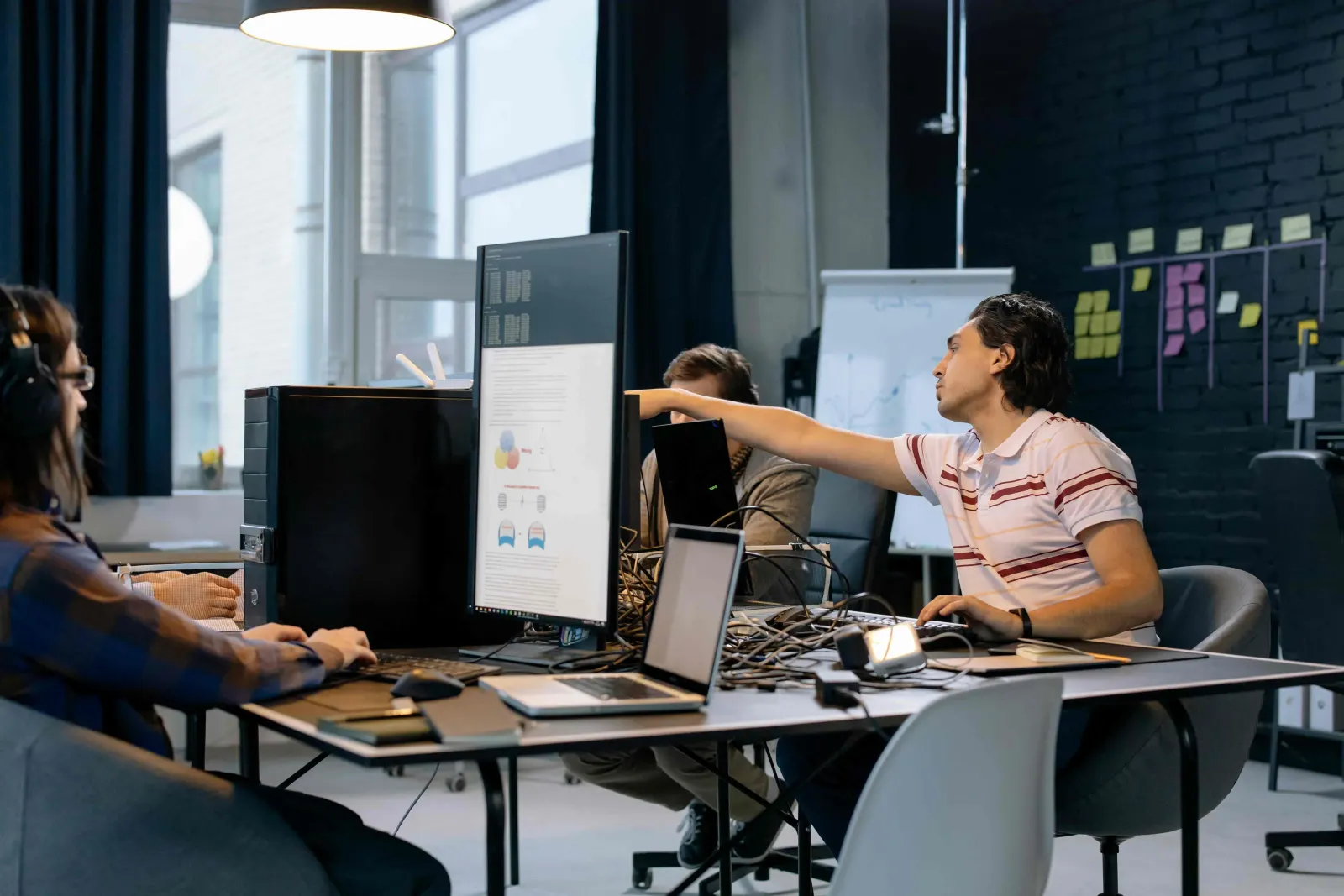 Startup founder walking a small room through a product idea on screen