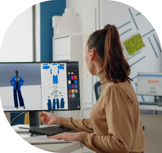 Female designer working on a 3D fashion modeling software, creating virtual outfits on a desktop computer in a modern creative workspace.