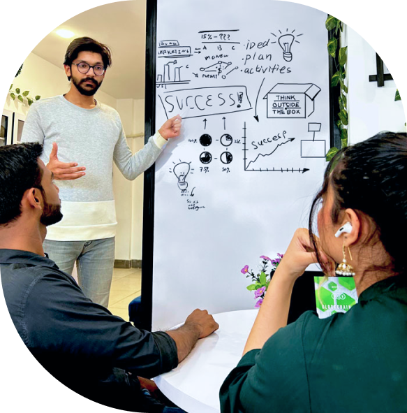 Business leader giving a strategy presentation using hand-drawn visuals on a whiteboard, inspiring team innovation and planning.