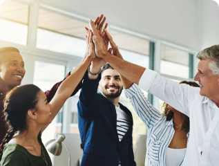 Diverse business team giving a group high-five in a modern office setting, celebrating success and teamwork.